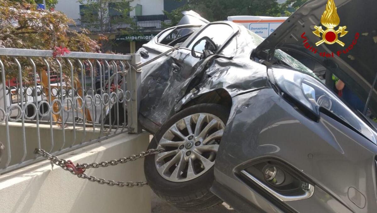 Scontro tra due auto: una finisce sopra una ringhiera - 