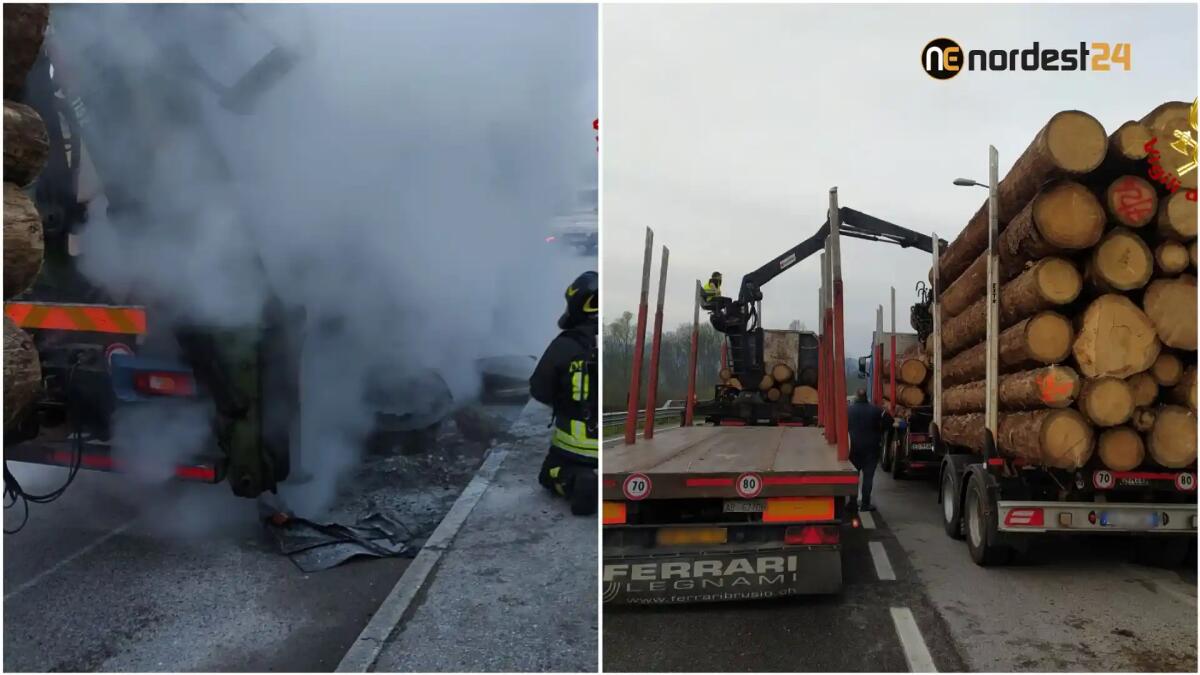 A fuoco il rimorchio di un camion carico di grossi tronchi - 
