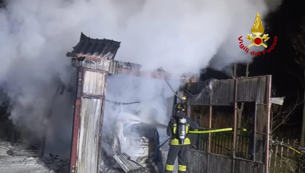 Prende fuoco una baracca in lamiera: le fiamme avvolgono un'auto e una bici parcheggiate - 